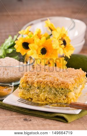 Rice timbale with zucchini on wooden table.
