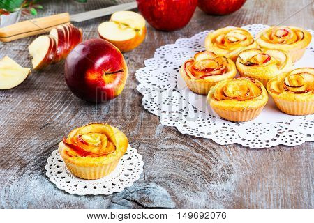 Muffin with rose shaped apple. Sweet apple dessert pie. Homemade apple rose pastry. Breakfast sweet apple muffins.