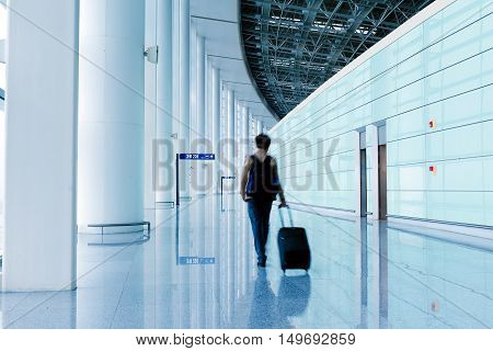 Passengers in the airport terminal building motion blur