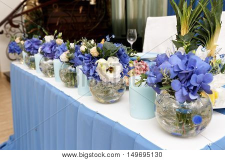 Decoration of wedding table with candles and flowers in blue tones selective focus