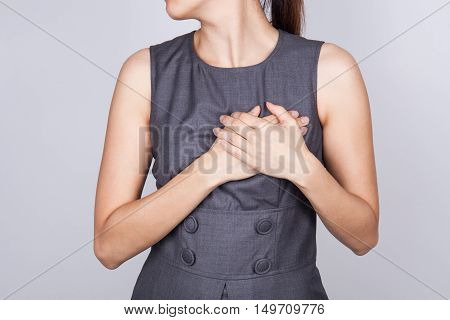 Woman is clutching her chest acute pain possible heart attack
