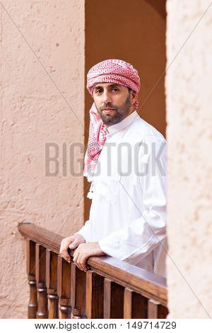 Young smiling handsome arabic man wearing traditional clothes