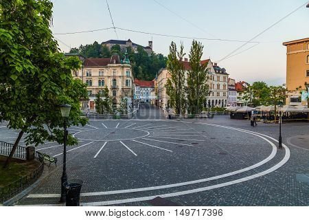 LJUBLJANA SLOVENIA - 27TH MAY 2016: A view towards Town Square Ljubljana Castle and Triple bridges during the morning from Preseren Square. Buildings and people can be seen.