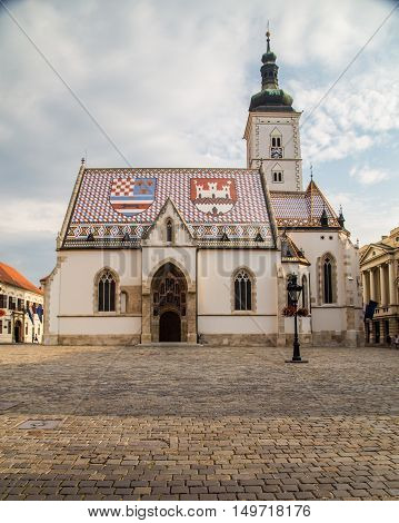ZAGREB CROATIA - 17TH AUGUST 2016: The outside of St Marks Church in central Zagreb Croatia during the day. People can be seen.
