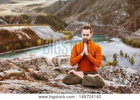 Man meditating on the Altay mountains background