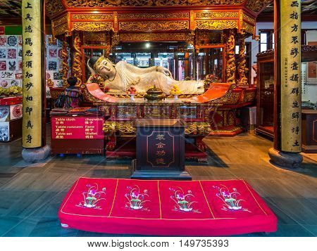 Shanghai China - October 26 2013: Buddha statue in the Jade Buddha Temple in Shanghai China. Buddhism is enjoying a revival in modern liberal China.
