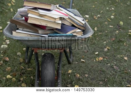 A garden trolley full of old book, outdoor shot with particular focus