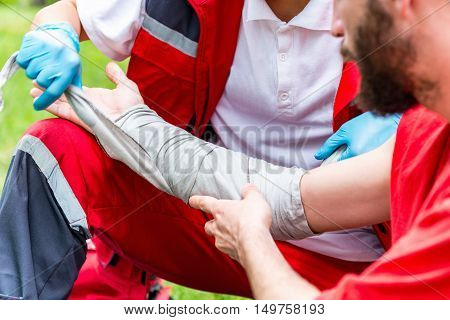 Medical Worker Treating Burns On Male's Hand