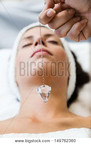 Beautiful Young Woman Receiving Gemstone Therapy In Spa.