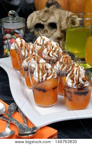 portioned dessert of pumpkin with whipped cream and chocolate topping on Halloween