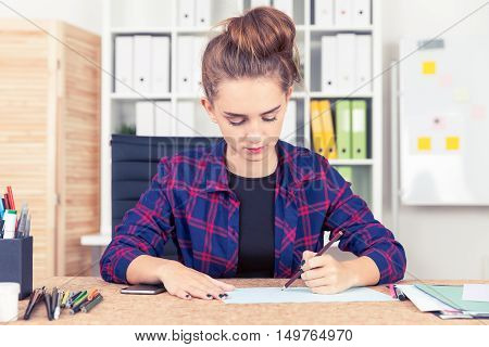 Woman Working At Blueprint