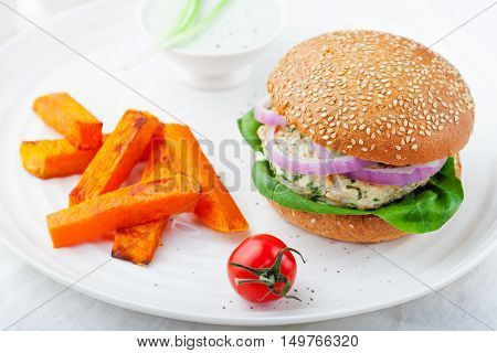 Burger with turkey, spinach, onion and roasted sweet potato, batat on a white background