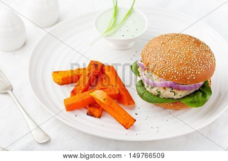 Burger with turkey, spinach, onion and roasted sweet potato, batat on a white background