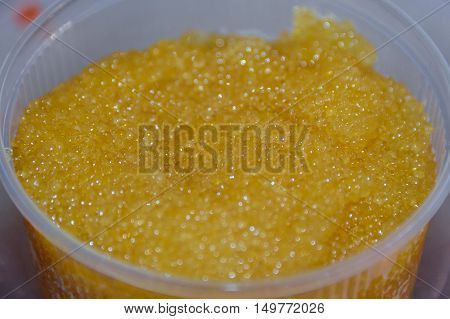Bank with pike ikroy.rasnoy closeup. Pails with caviar which houses the golden eggs. Each berry glows like a little emerald. Vladimir market. Kiev. Ukraine. 09/30/2016