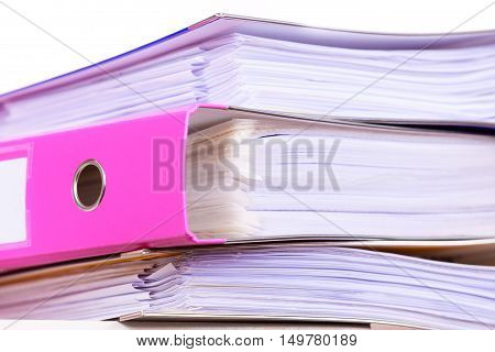 Paperwork. Stack of file folders ring binders on office table dask.