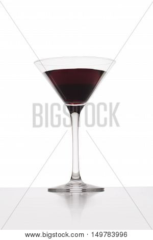 Red cocktail in martini glasses over white background