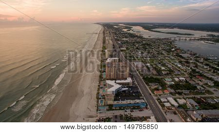 Aerial view of sunrise in Florida showing beach, rivers and bridges