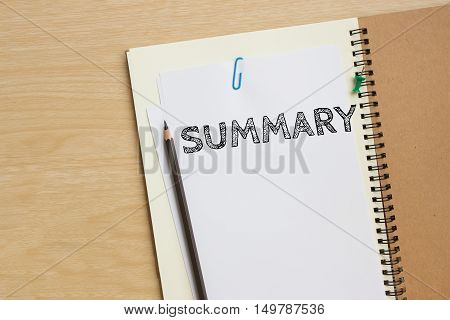 Text Summary on white paper and pencil on the desk / top view / business concept