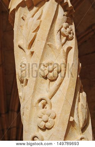 Lisbon, Portugal - October 21, 2014. Column intertwined with flowers at Mosteiro dos Jeronimos in Lisbon