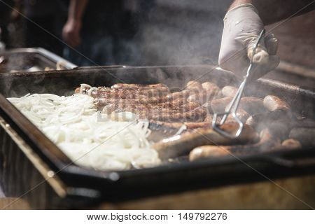 Fresh German Sausages With Onions On Grill, Bratwurst
