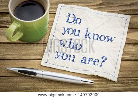 Do you know who you are ? A question on a napkin with a cup of coffee.