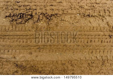 Texture of the soil, soil texture, nature background, ground, tire tracks on the ground