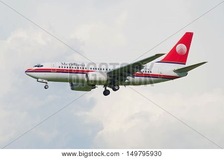 SAINT PETERSBURG, RUSSIA - AUGUST 24, 2016: Flying the Boeing 737 Next Gen (EI-FFM) airlines Meridiana in the cloudy sky.