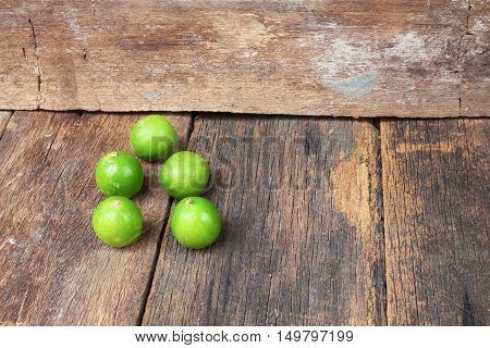 lemon with green on the wooden table top view