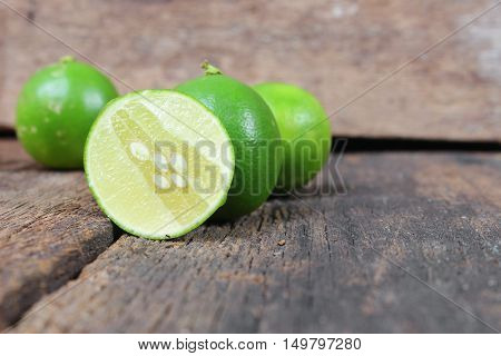 limes closeup Select focus with shallow depth of field on the wooden table