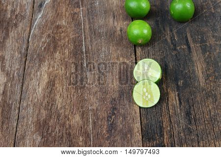lemon fresh green and slice lime on wooden table top view