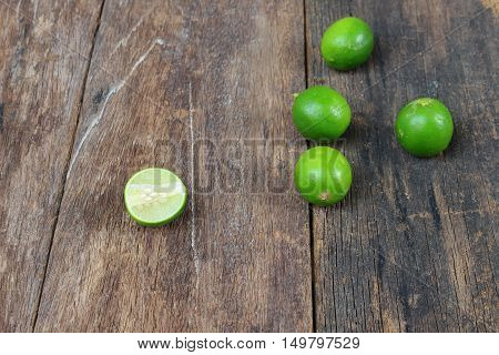 lemon fresh green and slice lime on wooden table top view