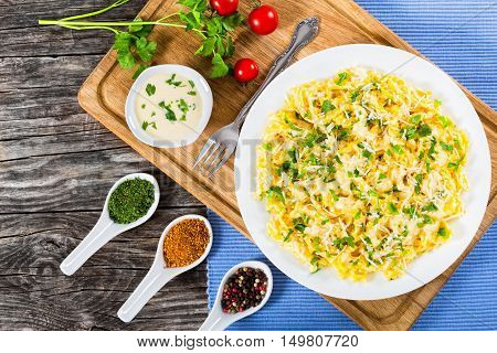 Fettuccine Alfredo served in a sauce of cream butter and grated Parmesan cheese sprinkled with parsley. view from above