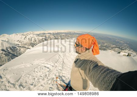 Adult Alpin Skier With Beard, Sunglasses And Hat, Taking Selfie On Snowy Slope In The Beautiful Ital