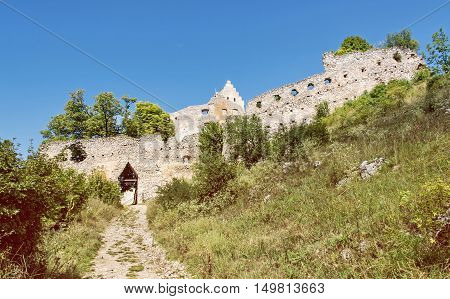 Access road to the ruin castle of Topolcany Slovak republic central Europe. Architectural theme. Beautiful place. Yellow photo filter. Travel destination.