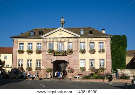 RIQUEWIHR, FRANCE - SEPTEMBER 13: Tourists on their way to the gate into the village Riquewihr in Alsace in France located by the Alsace wine route on September 13, 2016.