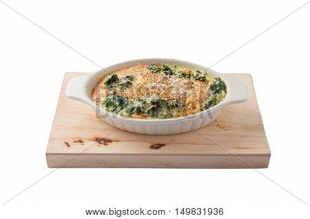 Front view of Modern style Spinach gratin (baked spinach with chesse) in ceramic bowl on wood plate isolated on white background