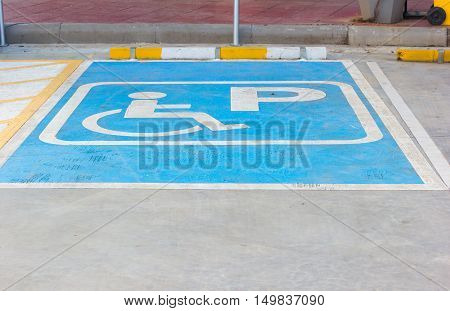 Disabled parking sign in filling station Thailand.