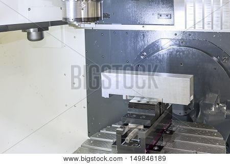 The work piece on the CNC milling machine.The CNC chamber room with the work piece