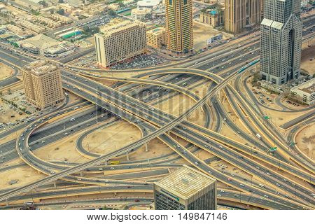 Aerial view of traffic on Sheikh Zayed Road highway interchange in Dubai downtown from the top in United Arab Emirates.