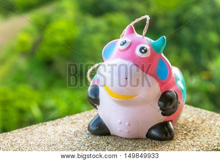 Ceramic doll on a stone pillar.For the interior decoration.