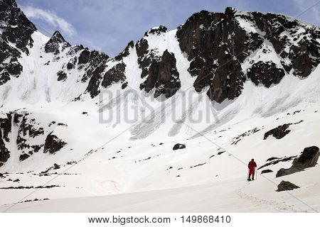 Hiker in snow mountain with trace from avalanches at sun spring day. Turkey Kachkar Mountains highest part of Pontic Mountains.