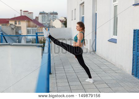 Fitness young woman in city in the evening. rear view.