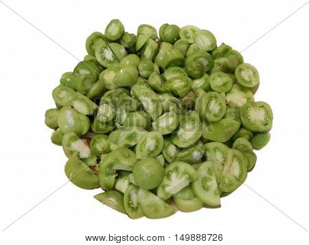 Heap of cut small green tomatoes on white background