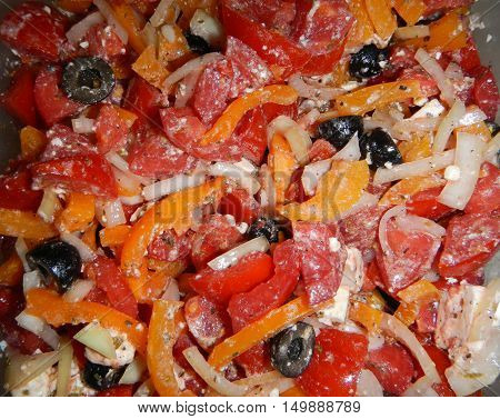 Multicolored salad with cream cheese red tomatoes white onion black olives red and yellow paprika