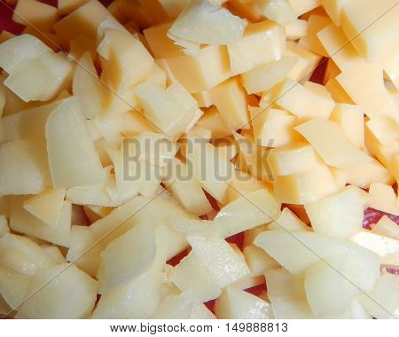 Heap of cut little pieces of white cream melon
