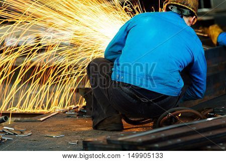 Workers at the construction site using a metal cutting torch