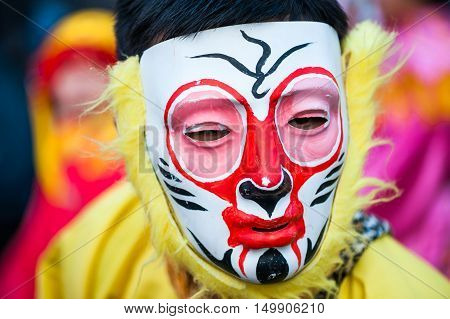 Paris France - Feb 17 2013: Chinese performer wearing a monkey mask in traditional costume at the chinese lunar new year parade
