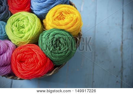 Blurry background colorful knitting in wooden basket