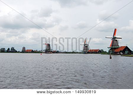 Traditional Dutch old wooden windmill in Zaanse Schans - museum village in Zaandam (Traditional village in Holland in Netherlands)