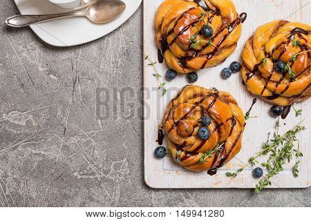Homemade pumpkin cinnamon yeasted buns, fall baking concept, top view